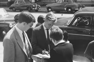 00242 Prints: Manchester United footballer Bobby Charlton signs autographs for young fans in Hyde Park