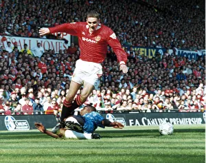 Premiership Prints: Manchester United footballer Colin McKee skips past the sliding challenge of a defender