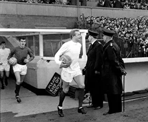 Police Officers Prints: Manchester United footballer Denis Law walks out onto the pitch before their match with