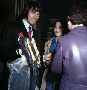 00230 Prints: Manchester United footballer George Best carrying his boots September 1969