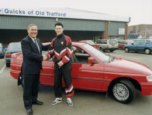 Manchester United footballer Ryan Giggs accepts the keys to his new car from Jim Quick