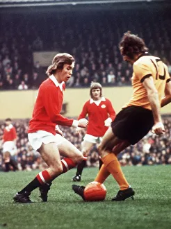 Challenge Prints: Manchester United footballer Sammy McIlroy battles for the the ball with Derek Dougan