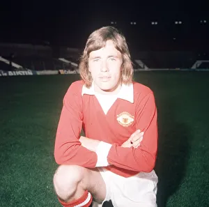 Arms Folded Prints: Manchester United footballer Sammy McIlroy poses during a pre season photocall at Old