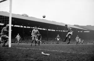 Manchester United forward Denis Law heads the ball towards goal during the league match