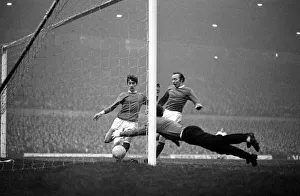 Manchester United goalkeeper Alex Stepney dives to pounce on the ball