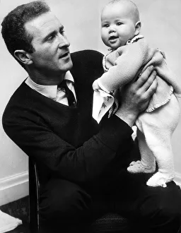 Man And Child Prints: Manchester United goalkeeper Harry Gregg with his four months old daughter Marianne