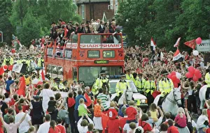 Manchester United Homecoming on open-top bus May 1999 is mobbed by fans