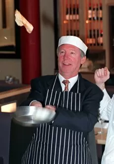 Images Dated 17th February 1999: Manchester United manager Alex Ferguson shows how its done on Shrove Tuesday as tosses a