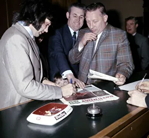 Manchester United and Northern Ireland footballer George Best signs autographs for a fan