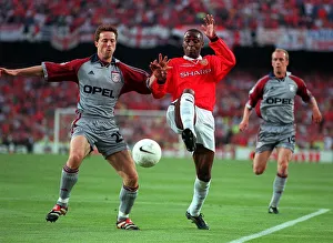 Manchester United player Andy Cole and Bayern Munich player Thomas Linke go for the ball
