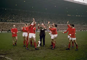 Manchester United players celebrate their League Championship win with manager Matt Busby
