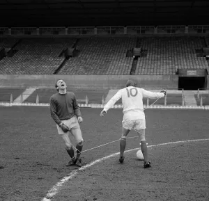 Manchester United players Nobby Stiles and Denis Law playing against each other during a
