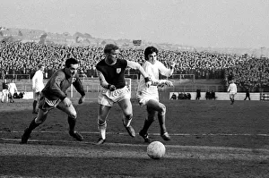 Manchester United star George Best dashes for the ball with Burnley goalkeeper Thomson