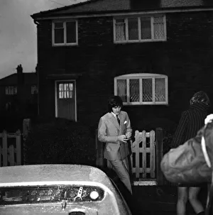 Manchester United star George Best leaving the house to go to the match against