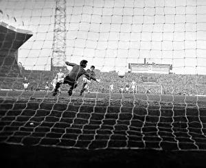 Manchester United star George Best scores past Manchester City goalkeeper Ken Mulhearn