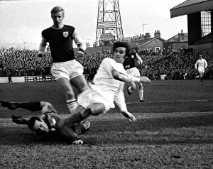 Manchester United star George Best shoots past Burnley goalkeeper Thomson watched by