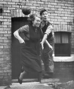 Manchester United starlet Bobby Charlton practices his heading skills with his mum