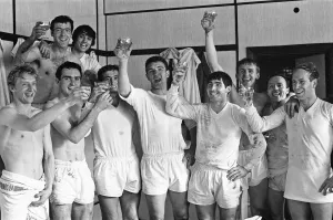Manchester United team celebrate with champagne in the dressing room after winning