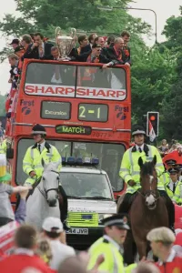 Manchester United team on open top bus May 1999 during their homecoming tour of