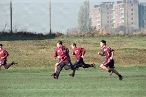 Manchester United in training. David Beckham running with Gary (hidden