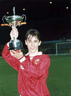 00372 Collection: Manchester United youth team player Gary Neville holds up the FA Lancashire Youth Cup
