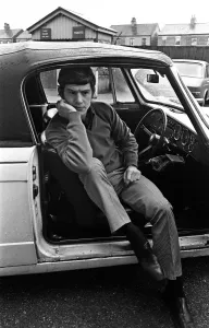 Manchester Uniteds Brian Kidd listening to the FA Cup draw on his car radio