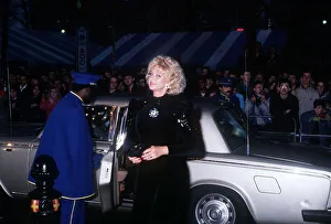 00745 Prints: Mandy Rice Davies premiere film Absolute Beginners black dress car door opened by caped