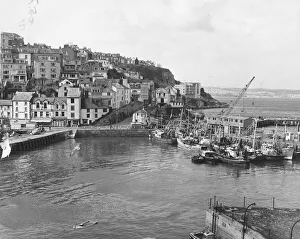 Boats Prints: Its March 1970 and work has begun extending the harbour at Brixham to provide