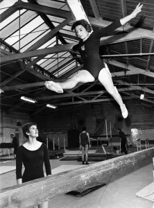 Gymnastics Prints: Margaret Bell does a splits jump, Mary Prestidge watches. September 1968 P011462
