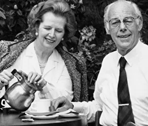 Margaret Thatcher and husband Denis drinking coffee in an outside cafe in a park - May
