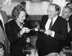 MARGARET THATCHER AND NEIL KINNOCK PULL A CRACKER AT A CHILDREN