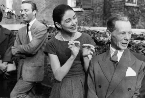 Margot Fonteyn and dancer Stanislas Izikowski talking in garden at party - October 1958