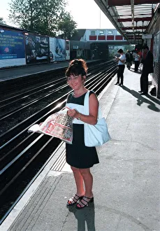 00139 Prints: Maria Smedley actress reading copy of Daily Mirror Newspaper while standing
