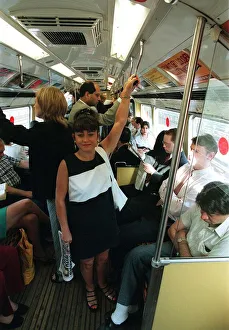 Maria Smedley actress standing on underground train holding on to hand rail
