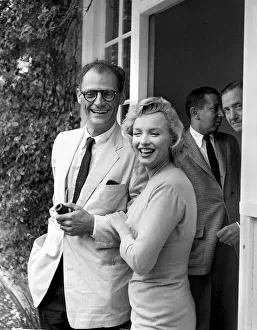Marilyn Monroe arm in arm with husband Arthur Miller July 1956. smiling