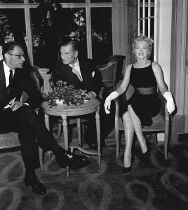 Men And Woman Prints: Marilyn Monroe with husband Arthur Miller and Laurence Olivier July 1956