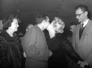 00066 Prints: Marilyn Monroe kisses Sir Laurence Olivier farewell as she leaves to go back to the U. S