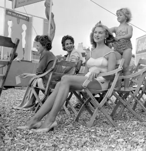 Marilyn Monroe look-a-like competition at Hastings. Child combing mothers hair