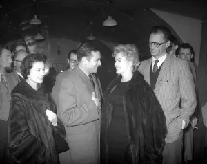 Marilyn Monroe says goodbye to Sir Laurence Olivier on her way back to the U. S