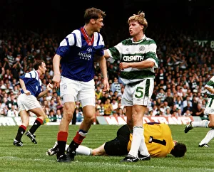 Pat Bonner Prints: Mark McNally argues with Duncan Ferguson as goalkeeper Pat Bonner lies injured football