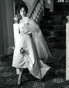 00181 Prints: Marla Scarafia Woman coming down the stairs pouting dramatically at the camera in a