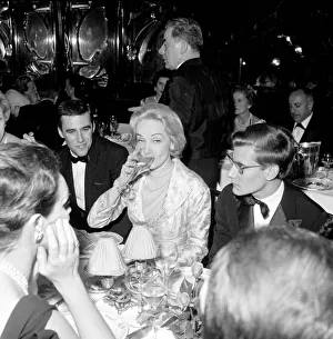 00161 Prints: Marlene Dietrich with Yves St. Laurant in Paris sitting at dinner table in
