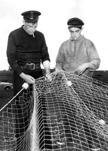 00091 Prints: Matthew Stanton and Henry Rowe repairing their fishing net in whcih a whale became