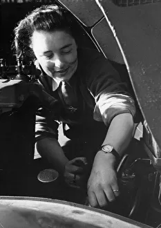 Repairs Prints: A mechanic of the Auxiliary territorial Service (ATS) busy at work on repairs to a