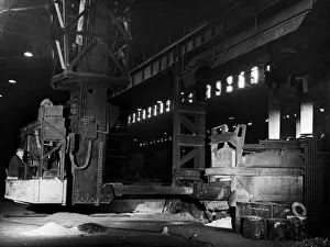 A mechanical charging machine feeding a 30 ton electric arc furnace at the English Steel