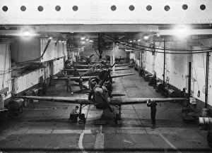 Repairs Prints: Mechanics working on the British Royal Navy aircraft carrier HMS Argus inside the hangar