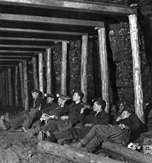 00030 Prints: Mechanized coal mining. A group of miners sit down for a rest while working underground