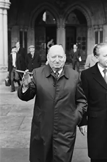 Trials Prints: Media Mogul Lew Grade poses outside the High Court in London, smoking one of his cigars