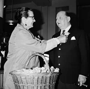 Vendor Prints: Media Mogul Lew Grade receives a flower frm seller Mrs Louise Noel at Simpsons of