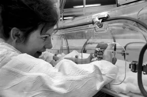 Medical. Mrs. Rosemary Letts holds baby Cara for the first time in the incubator